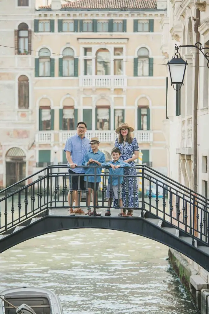 Image of a family posing on a bridge during a Venice photography shoot