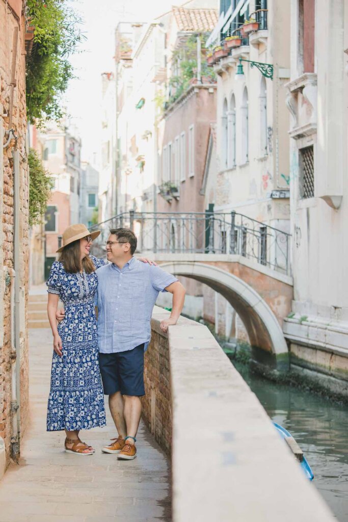 Image of a couple standing near a bridge in Venice, Italy