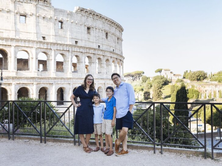 Find out how to spend 10 days in Italy with kids with tips by top family travel blog Marcie in Mommyland. Image of a family of four in front of the Colosseum in Rome.