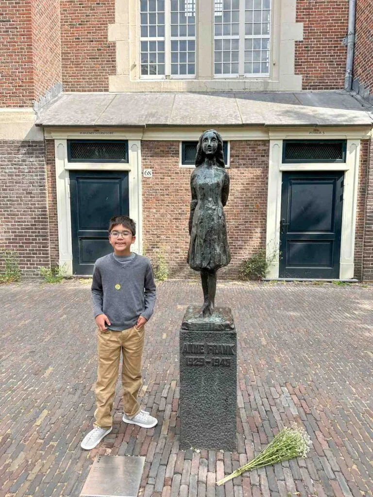Image of a boy with the Anne Frank statue in Amsterdam