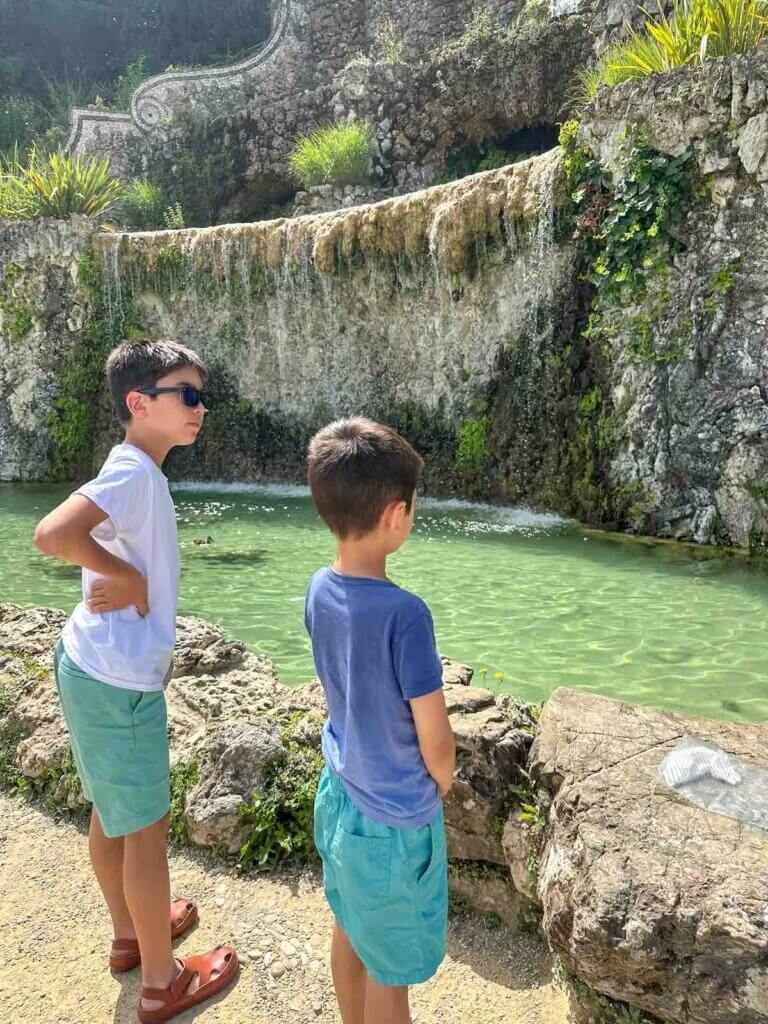 Image of two boys standing in front of a waterfall in Florence Italy