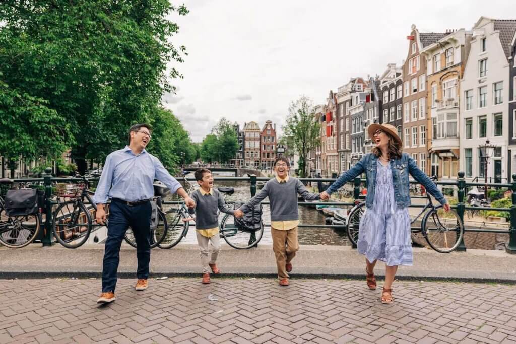 Image of a family of four laughing while crossing the street in Amsterdam