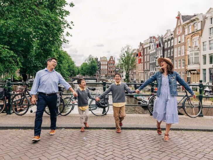 Image of a family of four laughing while crossing the street in Amsterdam