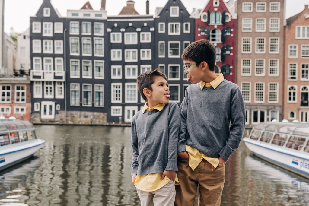 Image of two boys sticking their tongues out at each other during an Amsterdam photography session