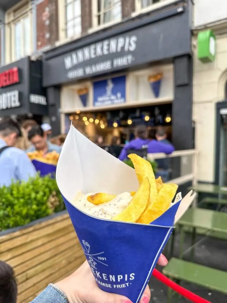 Image of a blue paper cone filled with french fries from Manneken Pis in Amsterdam