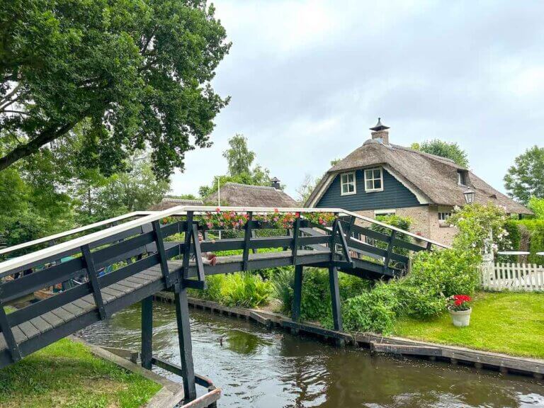 Is Giethoorn worth visiting as an Amsterdam day trip? See what top family travel blog Marcie in Mommyland says! Image of a cute canal town in the Netherlands