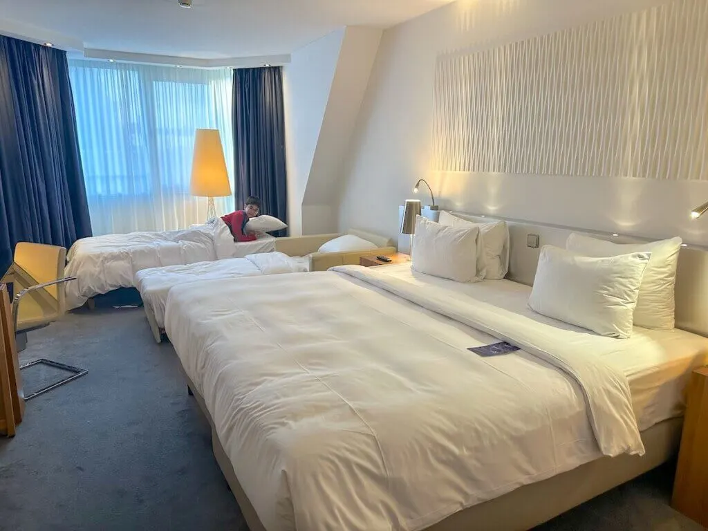 Image of a room with a king bed and two twin beds at the Radisson Blu in Amsterdam with kids