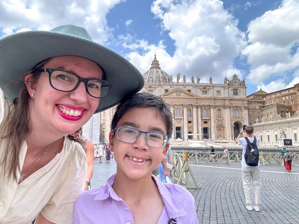 Find out whether or not it's worth touring the Vatican with kids with tips from top family travel blog Marcie in Mommyland. Image of a mom and son in front of St. Peter's Basilica