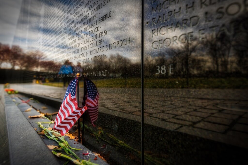 Image of An American flag placed at the Vietnam Veterans Memorial in Washington, DC on Independence Day.