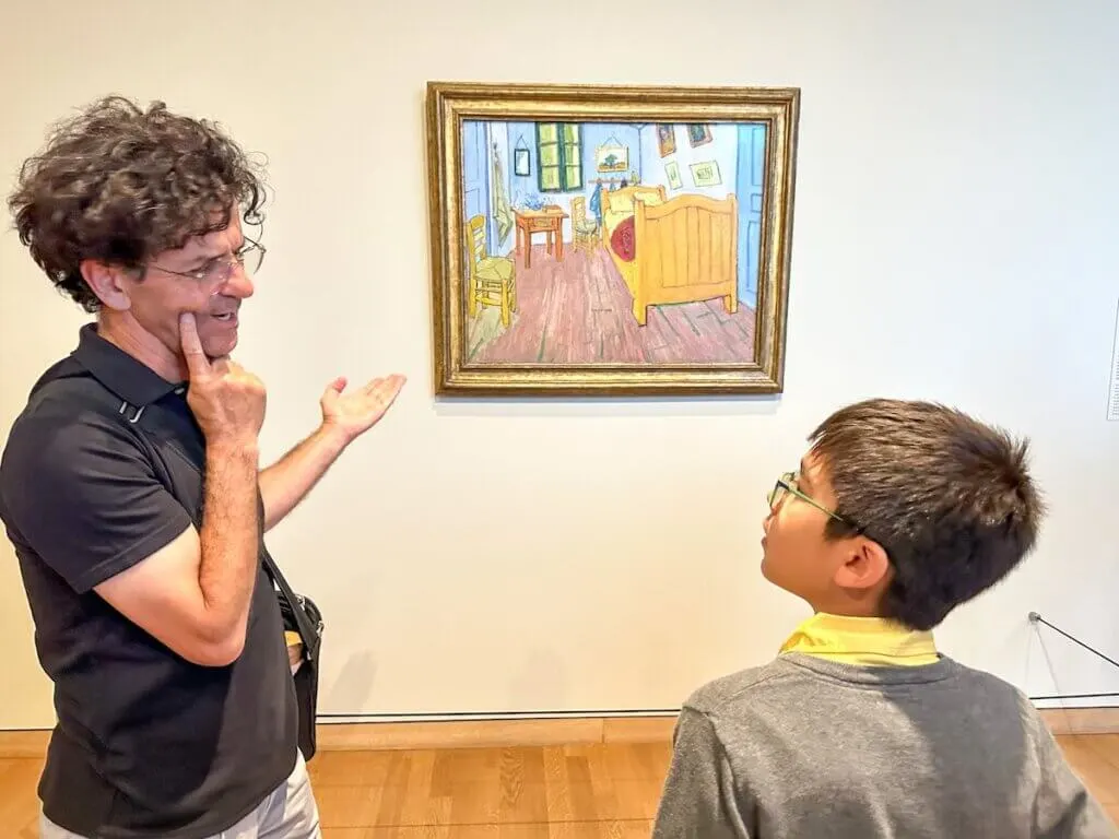Image of a man and a boy in front of a painting at the Van Gogh Museum in Amsterdam