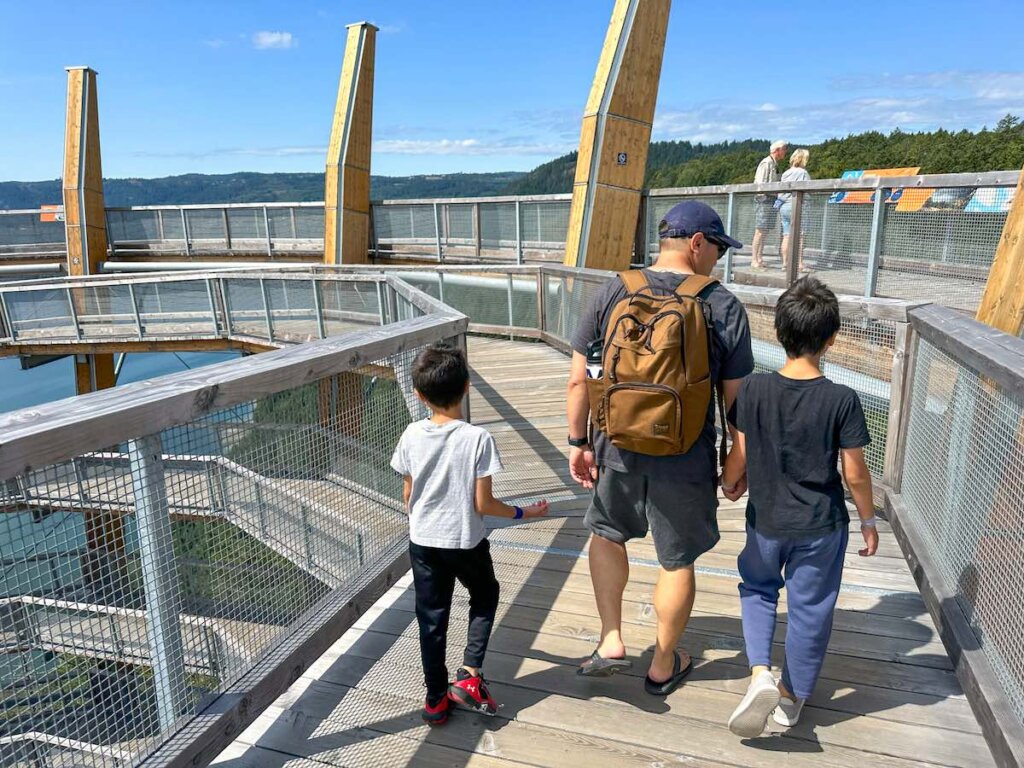 Image of a dad and two boys walking on the top of Malahat Skywalk in Vancouver Island