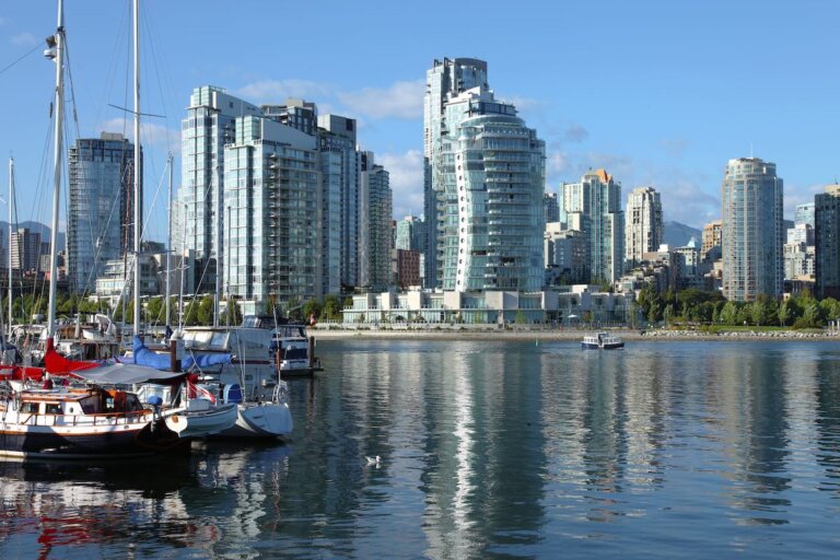 Check out the best Vancouver hotels for families recommended by top family travel blog Marcie in Mommyland. Image of Vancouver BC.,skyline at False Creek and moored sailboats.