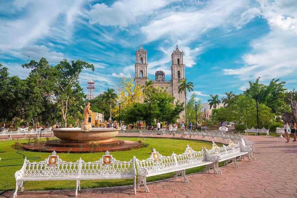 Cancun, Mexico. May 30, 2021. Footpath amidst garden and fountain with San Servacio church in Valladolild