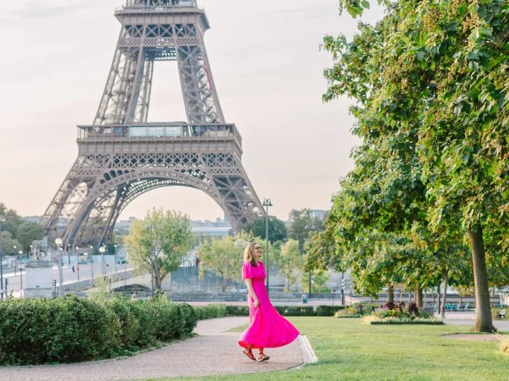 Find out how to plan a trip to Paris by top travel blog Marcie in Mommyland. Image of a woman in a pink dress in front of the Eiffel Tower