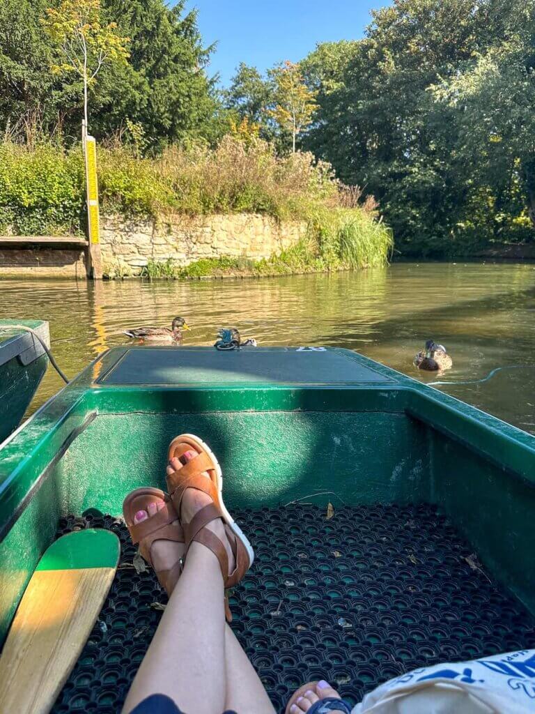 Image of a woman's legs in a punting boat in Oxford England