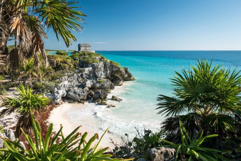 Find out the best Tulum family resorts in Mexico recommended by top family travel blog Marcie in Mommyland. Image of a beach in Tulum Mexico