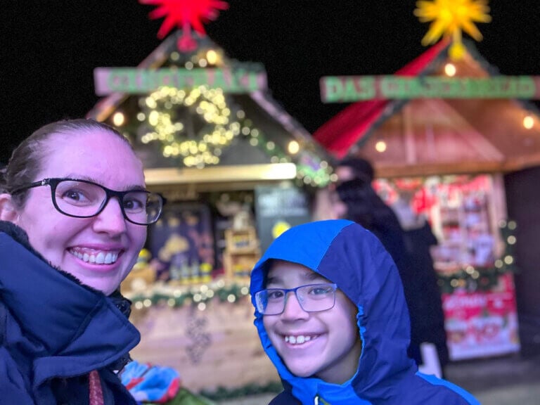 Find out the best things to do in Vancouver BC during Christmas recommended by top family travel blog Marcie in Mommyland. Image of Marcie Cheung and her son at the Vancouver Christmas Market