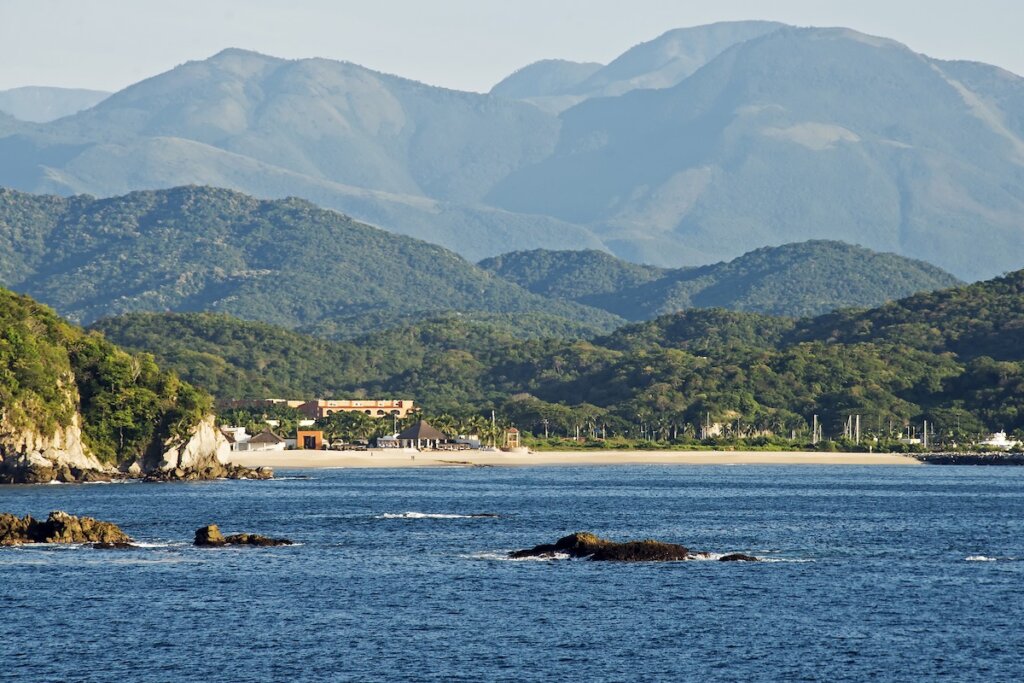 Image of Remote beach with Sierra Madre mountains in the Bays of Huatulco, Oaxaca, Mexico