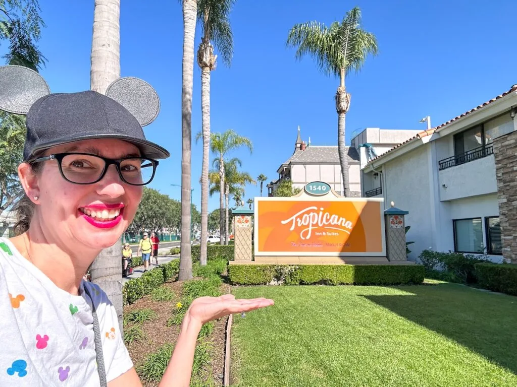 Image of Disney blogger Marcie Cheung in front of the Tropicana Inn sign at Disneyland