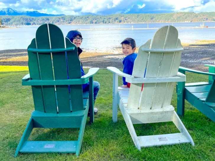 Check out these Family Resorts in Washington State recommended by top family travel blog Marcie in Mommyland. Image of two boys in Adirondack chairs at Alderbrook Resort in Washington State.