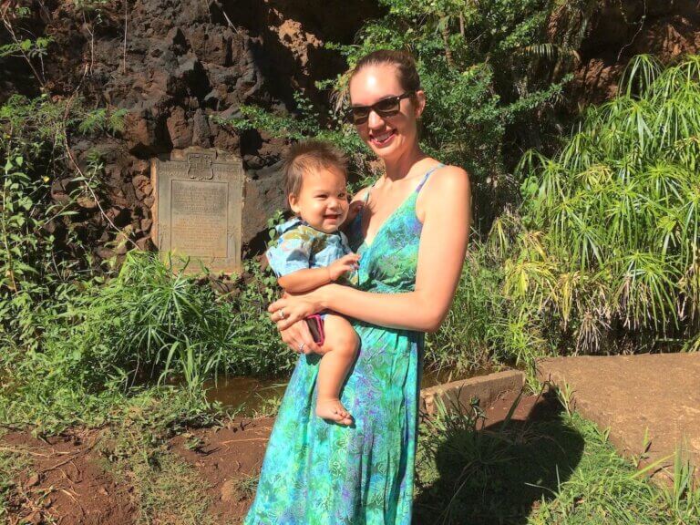 Check out these pro tips about visiting Hawaii with a baby by top family travel blog Marcie in Mommyland. Image of Marcie Cheung and her son on Kauai