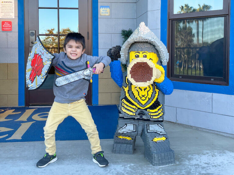 Get my ultimate LEGOLAND packing list with items recommended by top family travel blog Marcie in Mommyland. Image of a boy at LEGOLAND