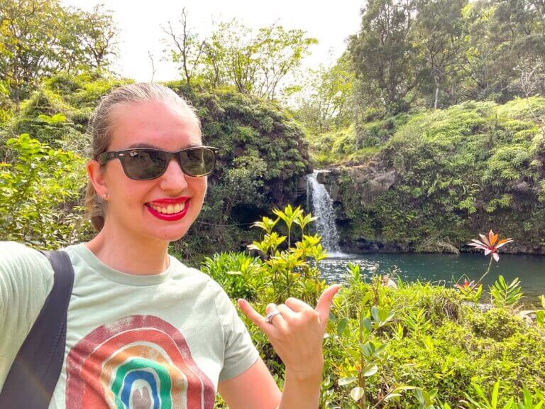 Check out these Maui travel tips recommended by top family travel blog Marcie in Mommyland. Image of Marcie Cheung of Marcie in Mommyland at a Road to Hana waterfall.
