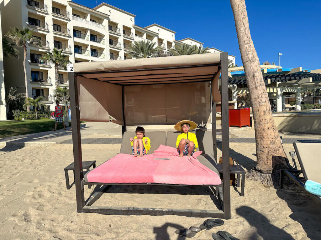 Image of two boys hanging in a cabana at a Mexico family resort. Photo credit: Marcie Cheung of Marcie in Mommyland