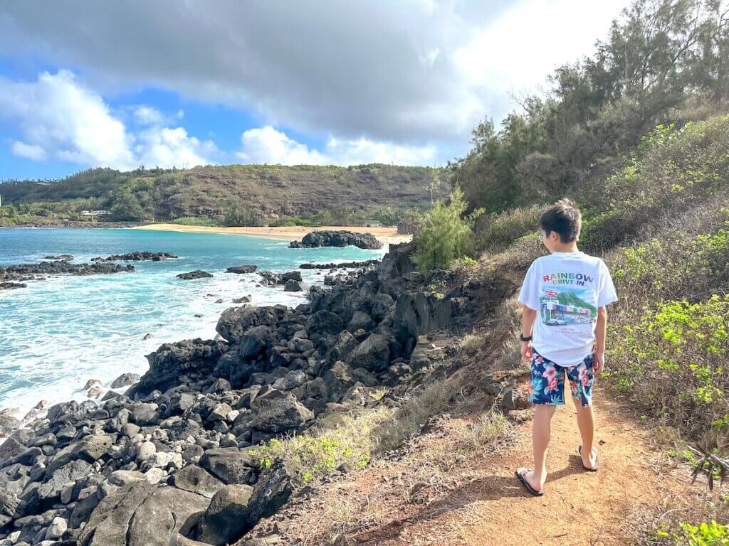 Image of a boy on a trail at Sunset Beach on Oahu. Photo credit: Marcie Cheung of Marcie in Mommyland.