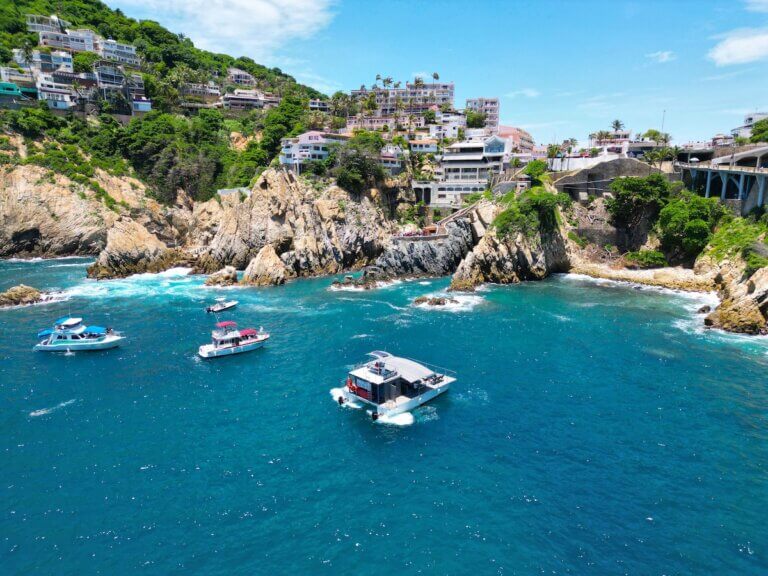 Check out this comparison of Acapulco vs Puerto Vallarta Mexico by top family travel blog Marcie in Mommyland. Image of Aerial View of the Quebrada with Yachts in Acapulco