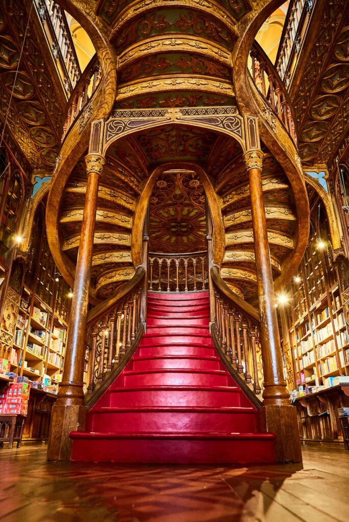 Image of Large wooden staircase with red steps inside library bookstore Livraria Lello in historic center of Porto, famous for Harry Potter film.