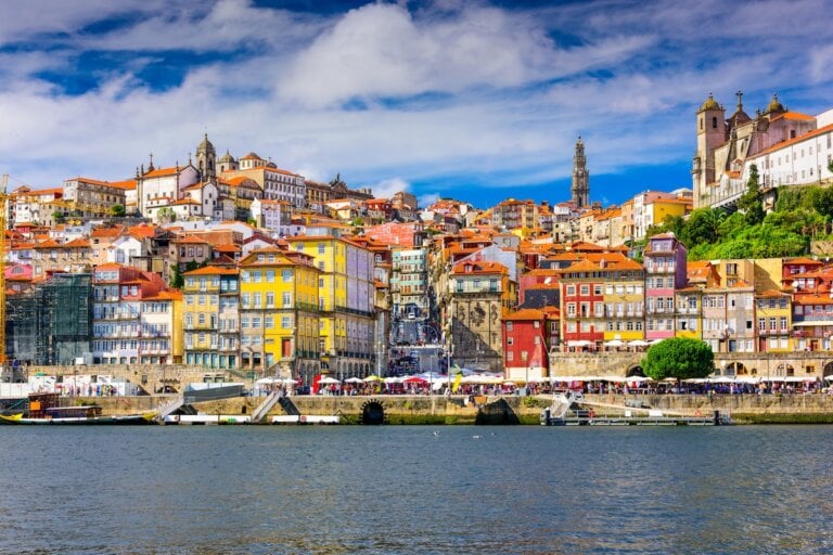 Check out this list of things to do in Porto Portugal by top family travel blog Marcie in Mommyland. Image of Porto, Portugal old town skyline from across the Douro River.