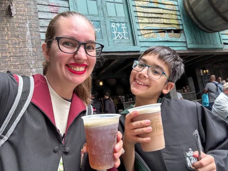 Check out this comparison of Universal Studios vs Disney World by top family travel blog Marcie in Mommyland. Image of Marcie Cheung and her son holding Butterbeer at Universal Studios Orlando.