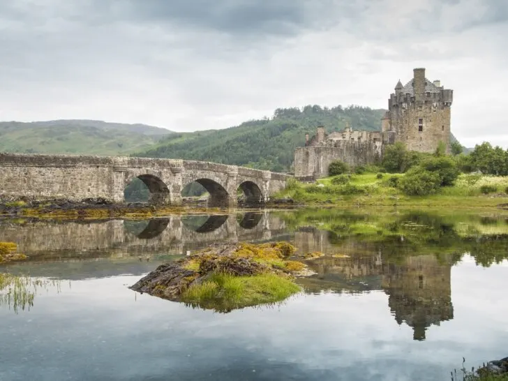 Find out how to plan a trip to Scotland with tips by top family travel blog Marcie in Mommyland. Image of most famous castle in Scotland. The Highlander location