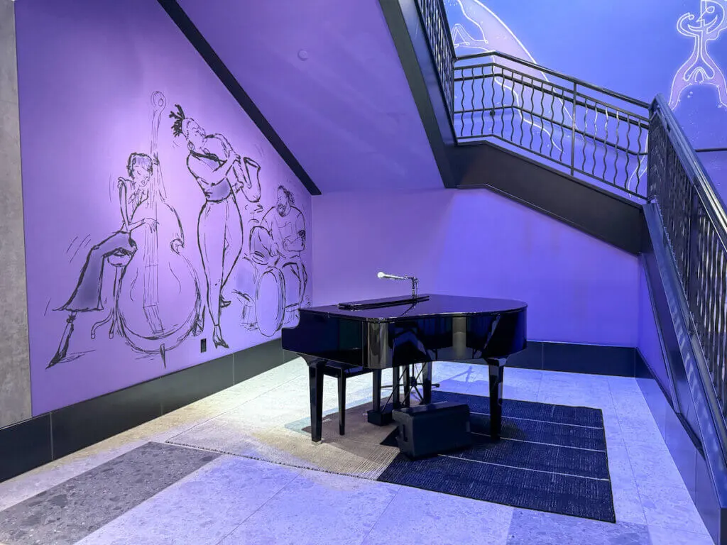 Image of a piano with a Disney Soul backdrop at the Pixar Place Hotel at Disneyland. Photo credit: Marcie Cheung