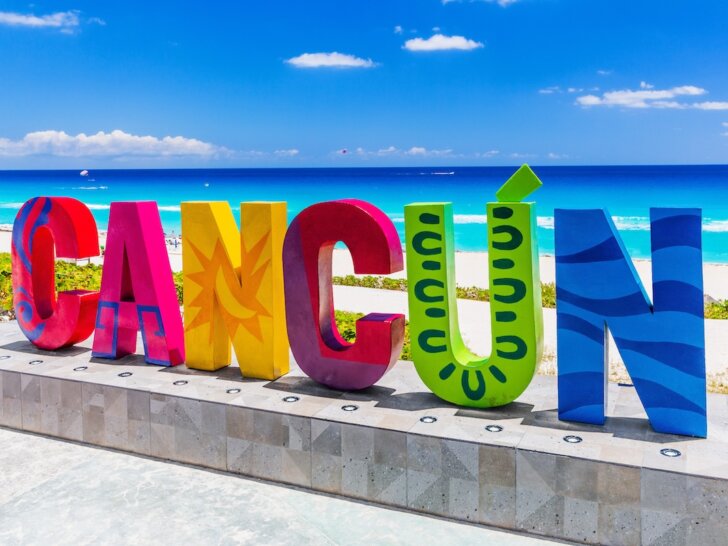 Check out the best things to do in Cancun with kids recommended by top family travel blog Marcie in Mommyland. Image of the Cancun Sign at Dolphin Beach.