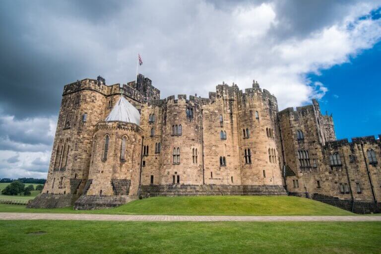 Check out this list of the best day trips from Edinburgh by train recommended by top travel blog Marcie in Mommyland. Image of Alnwick Castle in Alnwick in the English county of Northumberland, United Kingdom. It is a location for films and programs.