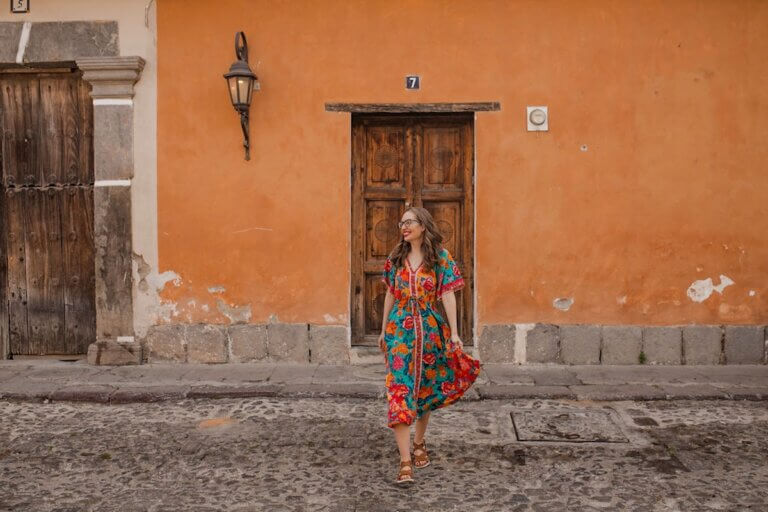 Find out the best things to do in Antigua Guatemala by top family travel blog Marcie in Mommyland. Image of Marcie Cheung crossing the street in Antigua.