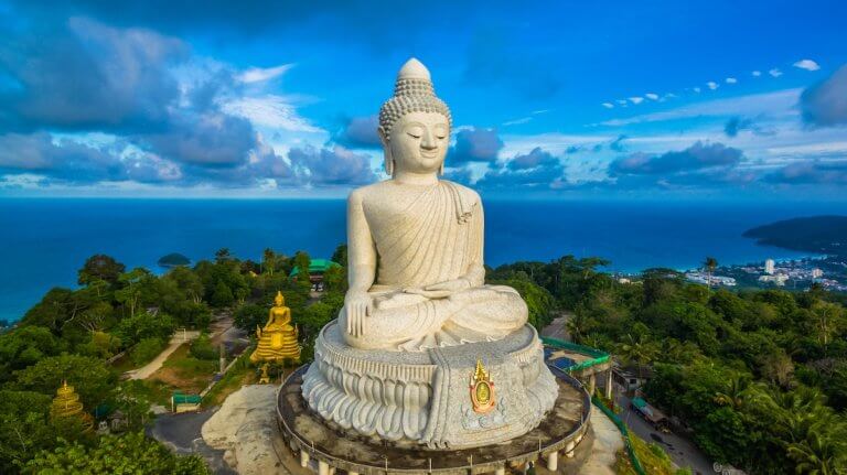 Find out the best things to do in Phuket with kids recommended by top family travel blog Marcie in Mommyland. Image of blue sky and blue ocean are on the back of Phuket Big Buddha statue.white Phuket big Buddha is the one of landmarks on Phuket island.