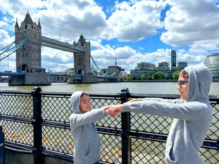 Find out how to spend 2 days in London with kids with tips from top family travel blog Marcie in Mommyland. Image of 2 boys in front of Tower Bridge in London