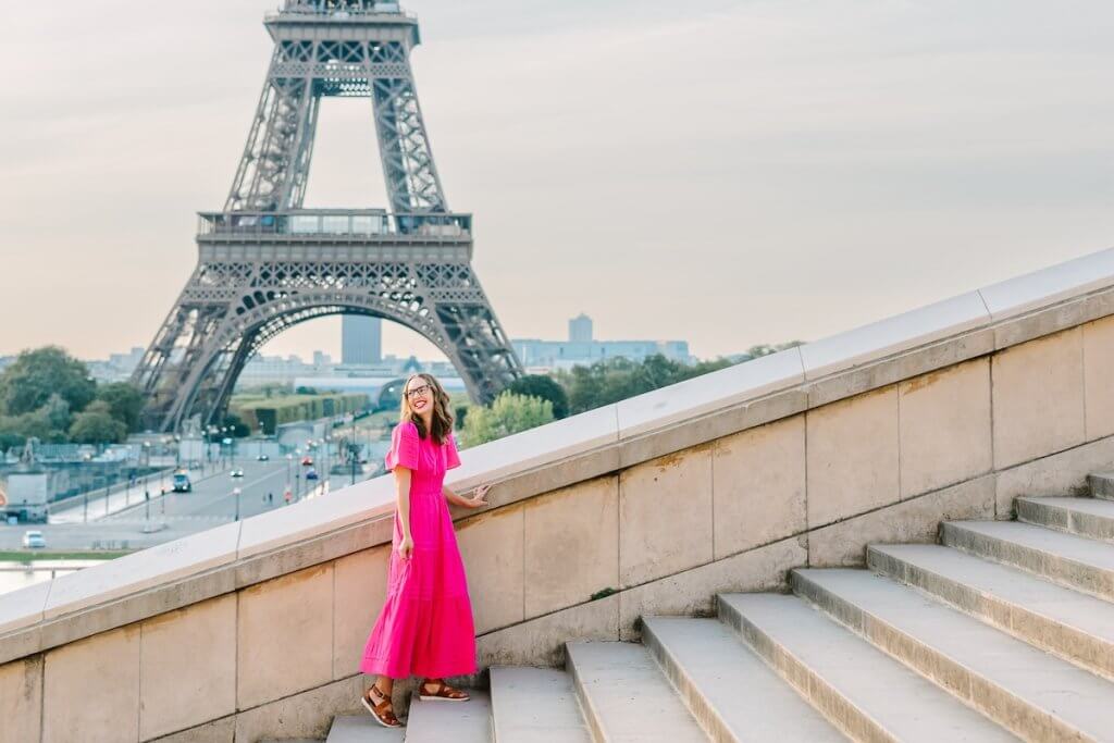 Find out how to visit Paris without the crowds with tips from top family travel blog Marcie in Mommyland. Image of Marcie Cheung in front of the Eiffel Tower.