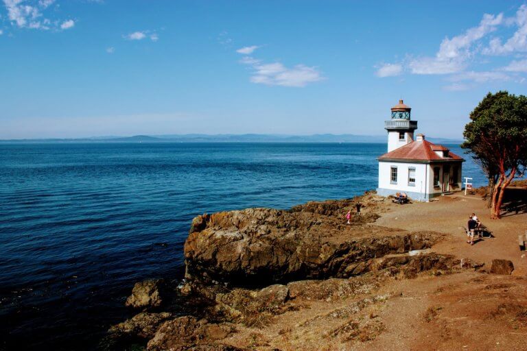 Find out the top U.S. travel destinations for summer that have low crowds and aren't hot. Image of a lighthouse on Orcas Island, WA