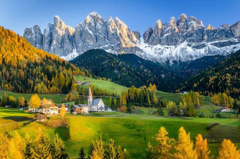 Find out the best European fall destinations for families recommended by top family travel blog Marcie in Mommyland. Image of the Dolomites in the fall