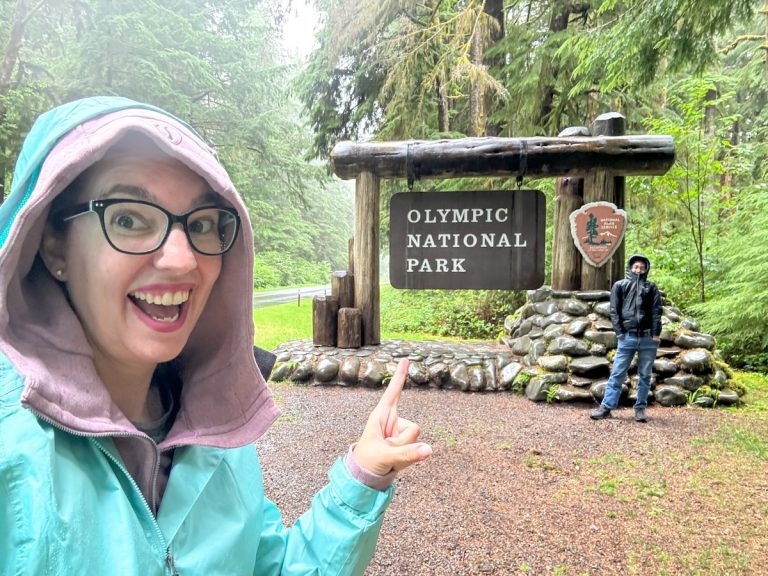 Find out my top tips for Olympic National Park with Kids! Image of Marcie Cheung and her son in front of the Olympic National Park sign