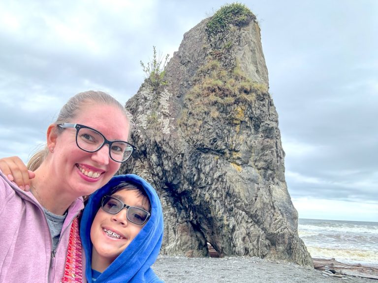 Find out the best things to do at Olympic National Park with kids! Image of Marcie Cheung and her son in front of a rock in Olympic National Park