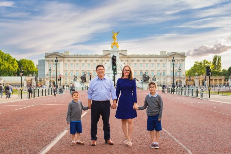 Image of Marcie Cheung and her family in front of Buckingham Palace in London