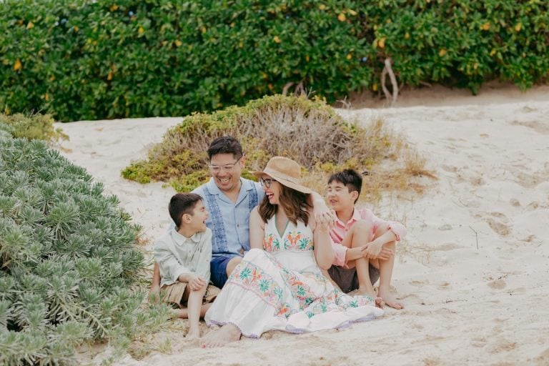 Find out how to book a Cancun photo shoot with tips from top family travel blog Marcie in Mommyland. Image of Marcie Cheung and her family on the beach in Mexico