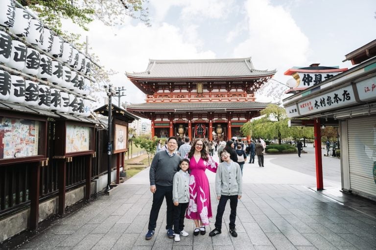 Find out how to plan a trip to Tokyo like a pro! Image of Marcie Cheung and her family in front of a temple in Tokyo