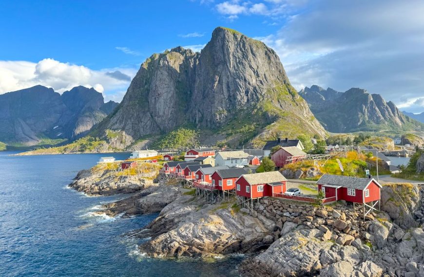 Find out how to plan a trip to the Lofoten Islands in Norway with tips from top travel blogger Marcie in Mommyland. Image of a fishing village