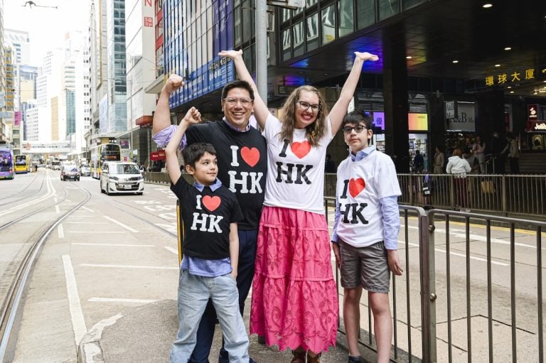 Check out this 5-day Hong Kong itinerary for families. Image of Marcie Cheung and her family wearing I heart Hong Kong t-shirts.